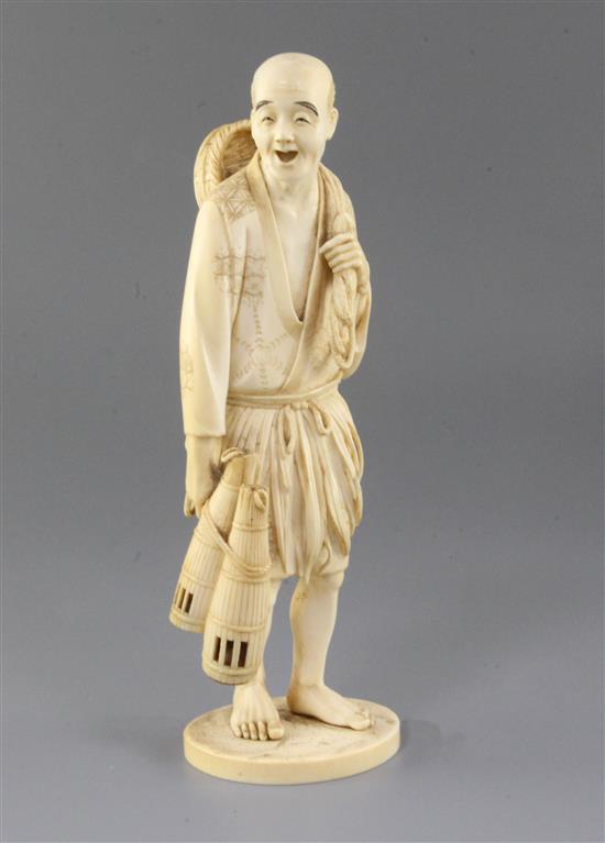 A Japanese ivory okimono of a fisherman, Meiji period, 26cm